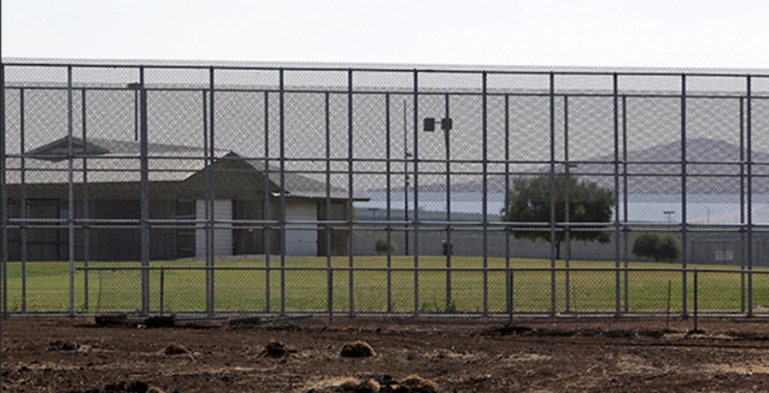 The front of the Porterville Developmental Center behind a security fence.