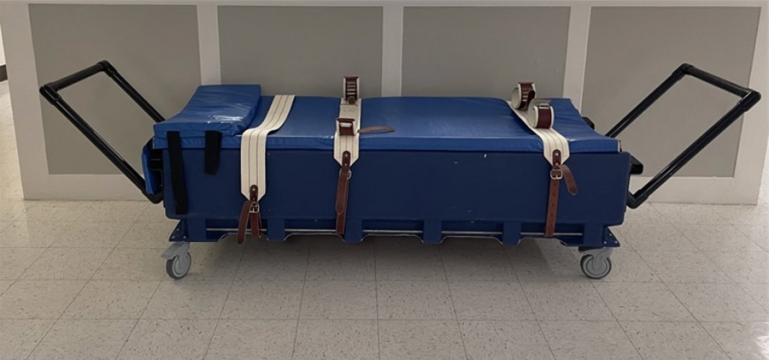This image is an example of a bed used for mechanical restraint, specifically five-point restraint.