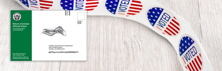 A collage showing the envelope used to mail in a ballot and a small sticker roll. The stickers have a little I Voted symbol.