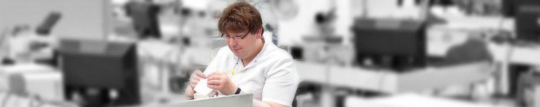 Photo of a person with a disability working in a assembly line