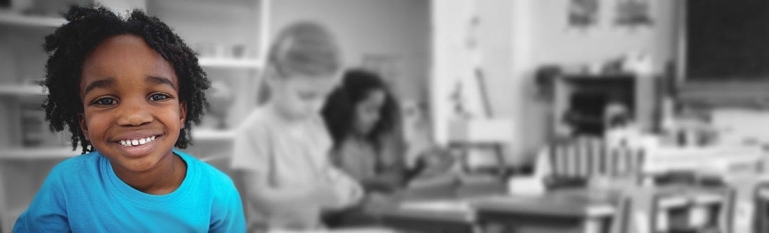 A black child in a school classroom.