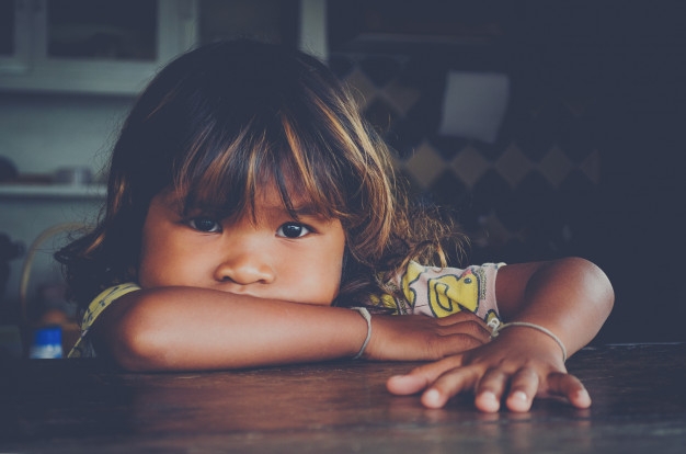 Photo of a girl that looks like she's being scolded.