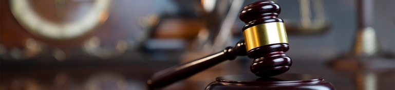 The law concept background. Gavel of the judge on the gray background.