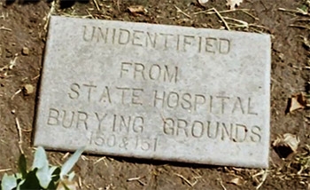 Photo of a grave marker of an unidentified person at a state hospital
