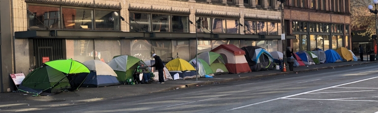 Photo of many tents on a street full of homeless people