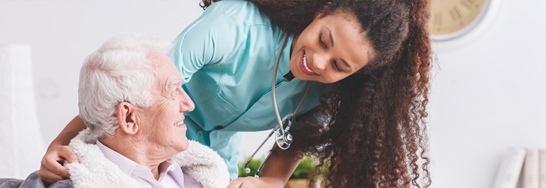 Nurse taking care of an elderly patient at a hospital.