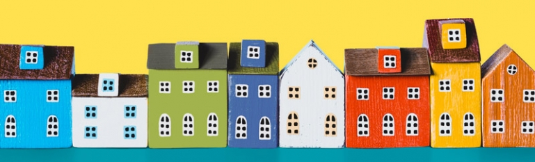 Illustration of several houses in a row. They are all different sizes.