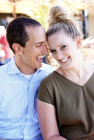 Photo of Katie with her significant other, both with huge smiles.