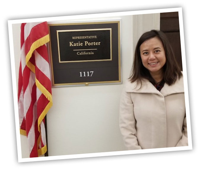 Female DRC employee standing in front of Congresswomen Porter's office.