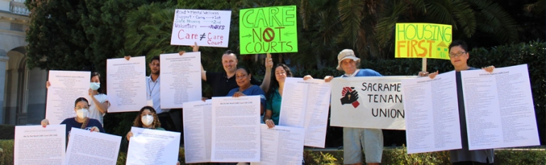 People holding protest signs in front of CA State Capitol saying No to CARE Court