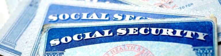 Close-up of several Social Security cards laid out on a table.