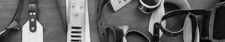 A black and white photo of different types of restraints on a table.