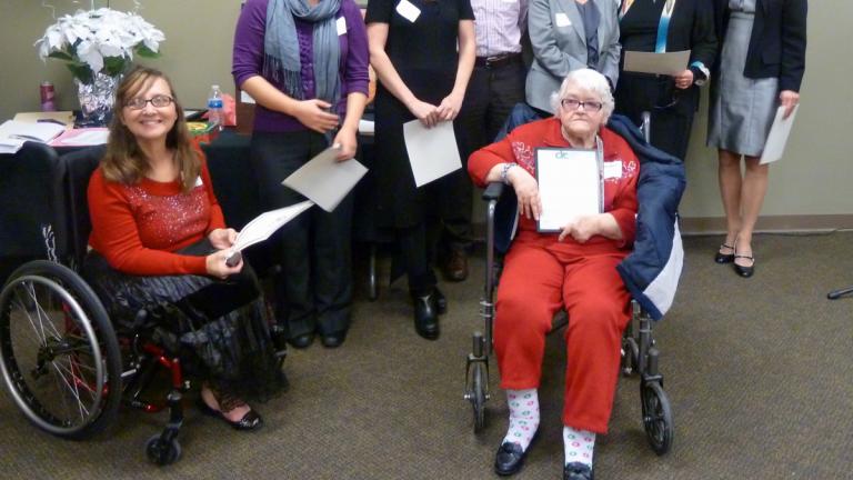 Photo of Esther Darling receiving a client award with her legal team besides her.