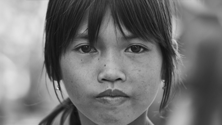 A close up image of the face of a young immigrant girl.