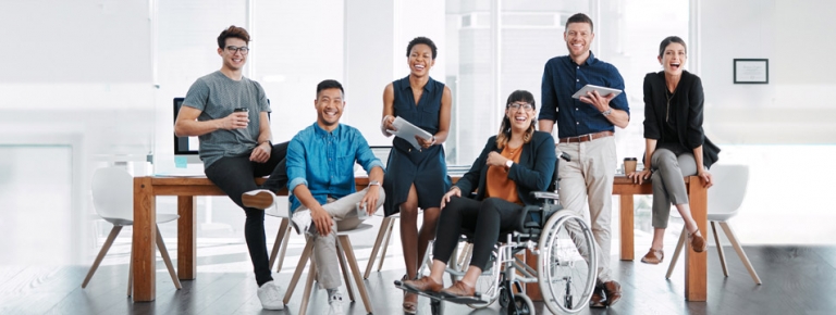 A group of employees at the office. One has a disability.